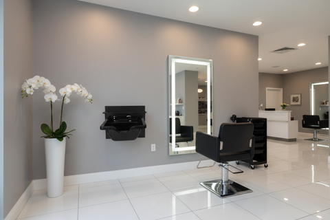 Black wall-mounted sink with basin on a white background